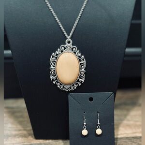 Cream color polished stone pendant on long silver tone chain and earrings set.